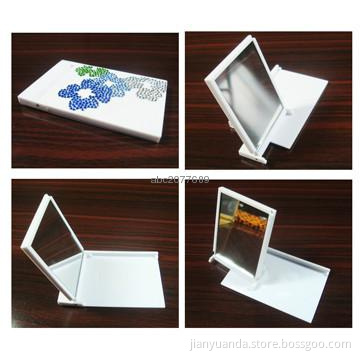 Rectangular plastic pocket mirror with revolving design